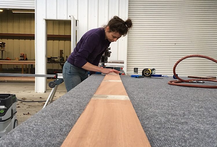 Lucia prepping the sapele. Wood ceiling installation for Mitsubishi Delica L300