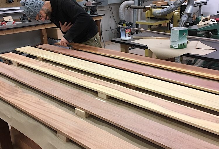 Colin putting finish on the ceiling pieces. Wood ceiling installation for Mitsubishi Delica L300